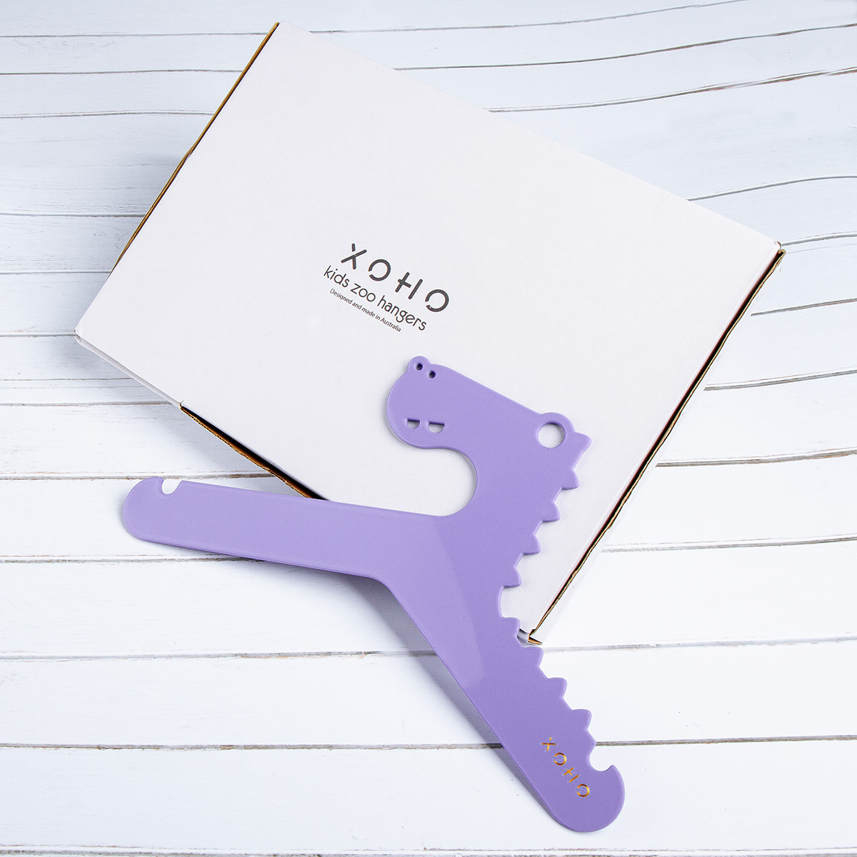 purple dinosaur clothes hanger on a gift box