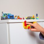 kid playing with legos on the handles of an ikea nordli drawer